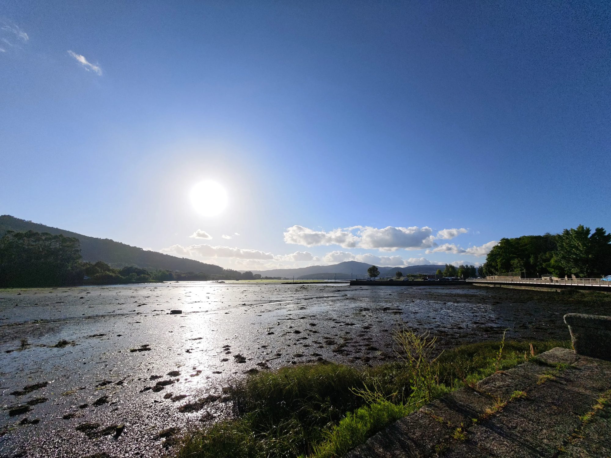 Low tide on the ría near Argalo, Noia, with the sun reflected on wet mud flats